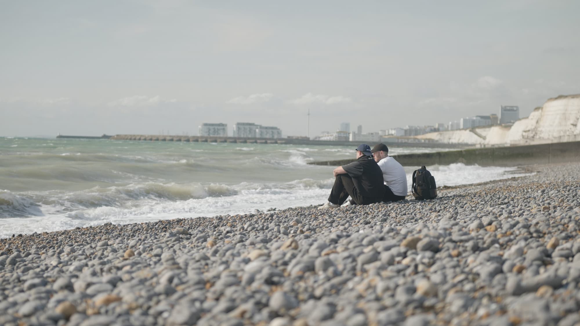 Two men sitting on the beach